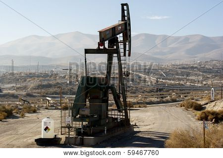 KERN COUNTY, CALIFORNIA - NOVEMBER 26, 2013: Pumpjacks extract oil from an oilfield in Kern County, CA. About 15 billion barrels of oil could be extracted using hydraulic fracturing in California.