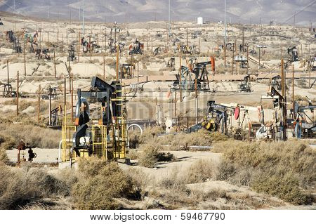 KERN COUNTY, CALIFORNIA - NOVEMBER 26, 2013: Pumpjacks extract oil from an oilfield in Kern County, CA. About 15 billion barrels of oil could be extracted using hydraulic fracturing in California.