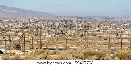 KERN COUNTY, CALIFORNIA - NOVEMBER 26, 2013: Pumpjacks extract oil from an oilfield in Kern County, CA. About 15 billion barrels of oil could be extracted using hydraulic fracturing in California.