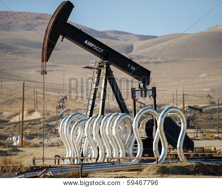 KERN COUNTY, CALIFORNIA - NOVEMBER 26, 2013: Pumpjacks extract oil from an oilfield in Kern County, CA. About 15 billion barrels of oil could be extracted using hydraulic fracturing in California.