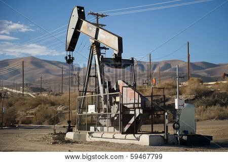 KERN COUNTY, CALIFORNIA - NOVEMBER 26, 2013: Pumpjacks extract oil from an oilfield in Kern County, CA. About 15 billion barrels of oil could be extracted using hydraulic fracturing in California.