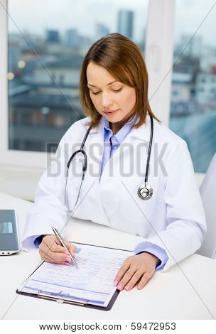 medicine and healthcare concept - busy doctor with laptop computer