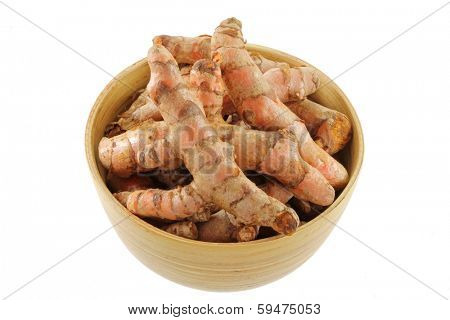 A bowl of Turmeric rhizome in a wooden bowl, main ingredient to cook Asian curry