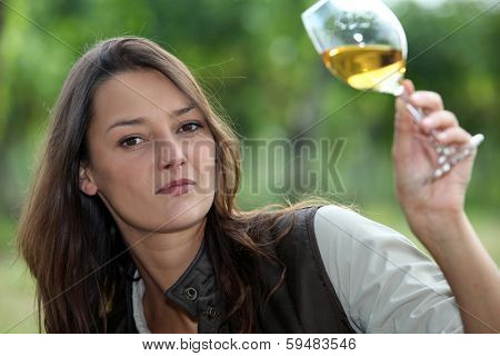 Woman looking glass of wine