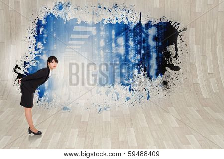 Serious businesswoman bending against splash showing data hallway