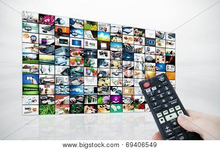 Big Lcd Panel With Television Stream Images And Remonte Control In Hand