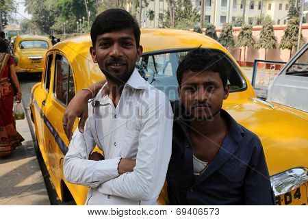KOLKATA, INDIA - FEBRUARY 14: Indian taxi driver posing in front of his cab in Kolkata on February 14, 2014. The car is Hindustan Ambassador, manufactured since 1958.