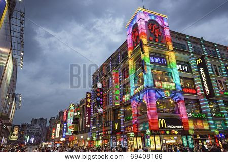 GUANGZHOU, CHINA - MAY 25, 2014: Pedestrians pass through Shangxiajiu Pedestrian Street. The street is the main shopping district of the city and a major tourist attraction.