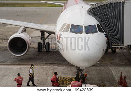 KUCHING - MAY 06: docked jet Airasia airplane on May 06, 2014 in Kuching, Malaysia. AirAsia Berhad is a Malaysian low-cost airline headquartered in Kuala Lumpur, Malaysia