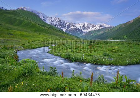 Summer landscape with the mountain river. Evening after sunset. Caucasus. Zemo Svaneti, Georgia