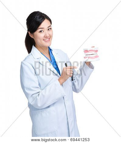 Asian female dentist show denture