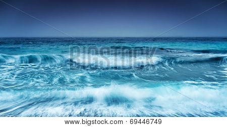 Dramatic stormy seascape, abstract natural background, overcast weather on the sea, big waves, slow motion sea waves