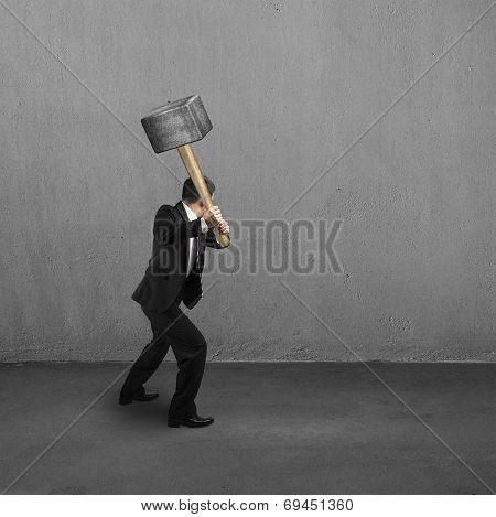 Using Big Hammer To Creak Wall