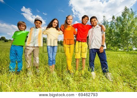 Happy kids standing in a row straight