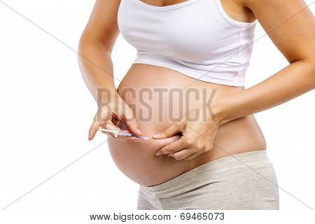 Pregnant woman with syringe