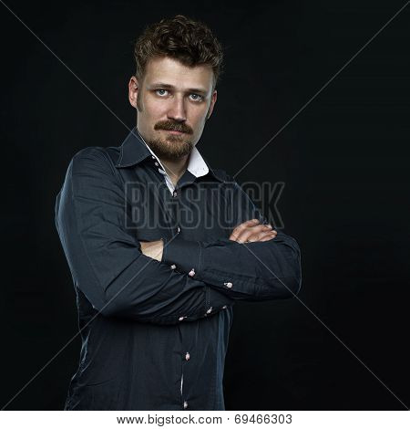 Three fourths Portrait of serious confident man, office worker with crossed arms