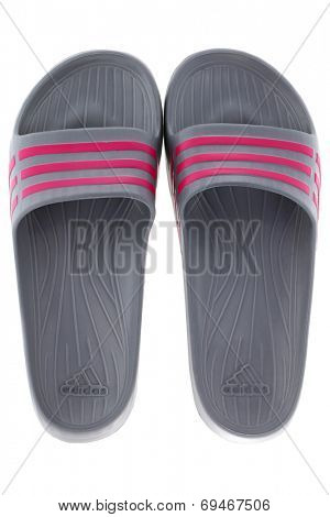 BANGKOK, THAILAND - JULY 2014 : A pair of Adidas Duramo Slide sandals in Graphite with pink stripes isolated on white on 12 July 2014 in Bangkok, Thailand.