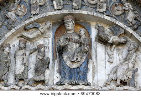PARMA, ITALY - MAY 01, 2014: Virgin Mary with baby Jesus on the baptistery from Benedetto Antelami. Baptistery in Parma is considered to be among the most important Medieval monuments in Europe. 