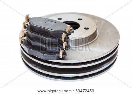 Two Metallic Brake Disks And Pads Isolated On White Background