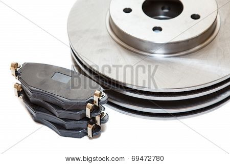 Two Brake Disks And Pads Isolated On White Background