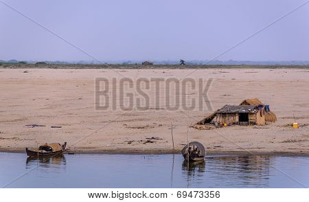 House And Boats On Riverbanks