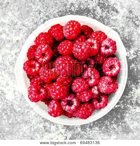 Ripe Raspberry In A White Bowl Over Vintage Textuted Background, Close Up...