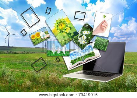 Laptop and images of nature on field and sky background