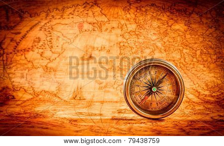 Vintage still life. Vintage compass lies on an ancient world map in 1565.