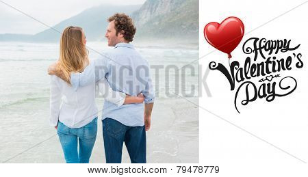 Rear view of a romantic couple at beach against cute valentines message