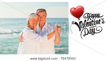 Mature couple dancing on the beach against cute valentines message