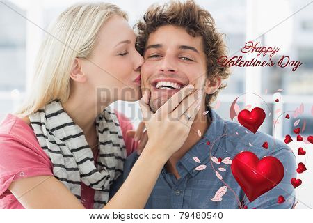 Woman kissing man on his cheek against cute valentines message