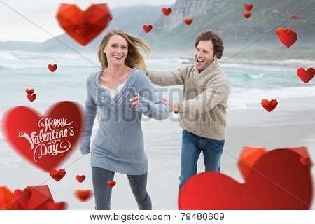 Cheerful couple running at beach against cute valentines message