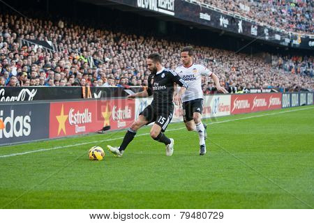 VALENCIA, SPAIN - JANUARY 4: Carvajal with ball and Piatti during Spanish League match between Valencia CF and Real Madrid at Mestalla Stadium on January 4, 2015 in Valencia, Spain