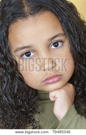 A beautiful mixed race African American little girl female child looking sad and sulking