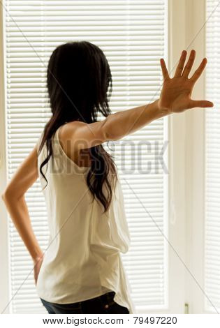 a woman being harassed and holds the hand to ward