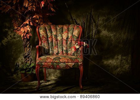Antique Empty Chair With Colorful Pattern And Plant.
