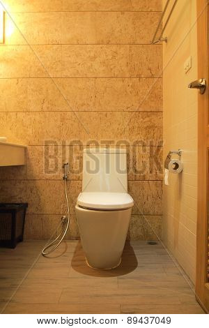 Closed Up Bathroom In Yellow Light