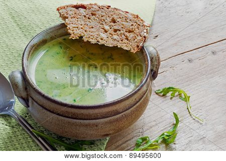 Green Cream Soup From Vegetables And Herbs With Bread In A Rustic Bowl On Old Wood