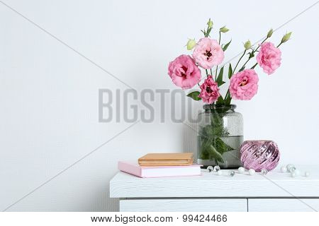Beautiful flowers with books on wall background