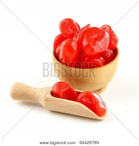Dried kumquat fruits in wooden bowl, isolated on white