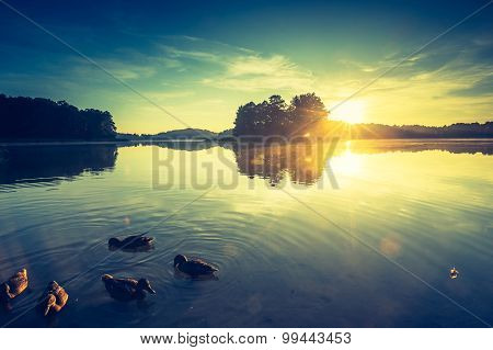 Vintage Photo Of Beautiful Sunrise Over Calm Lake.