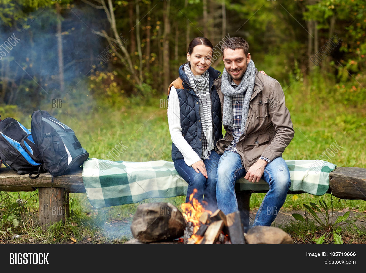 camping travel tourism hike and people concept happy couple sitting on bench camping in the woods m90 camping