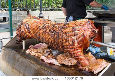Spit Roasting Pork With Succulent Crackling Ready For Carving.