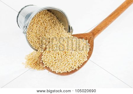 Bucket Of Millet Crumbles In The A Wooden Spoon