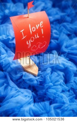 Toy Boat With Red Sails On Blue Background. I Love You. Heart
