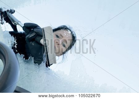 Woman Scraping Ice from a Windshield