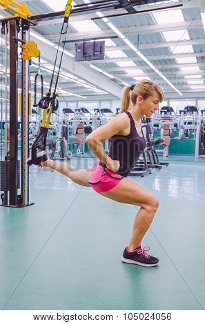 Woman doing suspension training with fitness straps