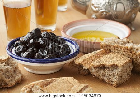 Moroccan traditional breakfast with olive oil,black olives,bread and tea