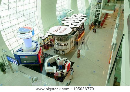 DUBAI, UAE - APRIL 18, 2014: the interior of Concourse A. The concourse includes one 4 star hotel and one 5 star hotel, first and business class lounges, and duty-free areas