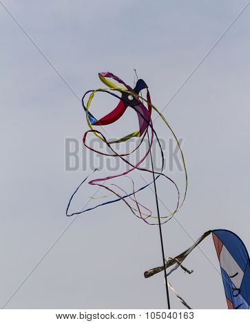 Colorful Kites Flying  In Single File In The Sky